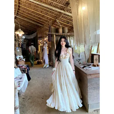 A Sweet Peach-Colored Yikett "Santorini" Heavy-Duty, Extra-Large Skirt Hem, Cinched Waist, Strap Dress for Women, Vacation Dress